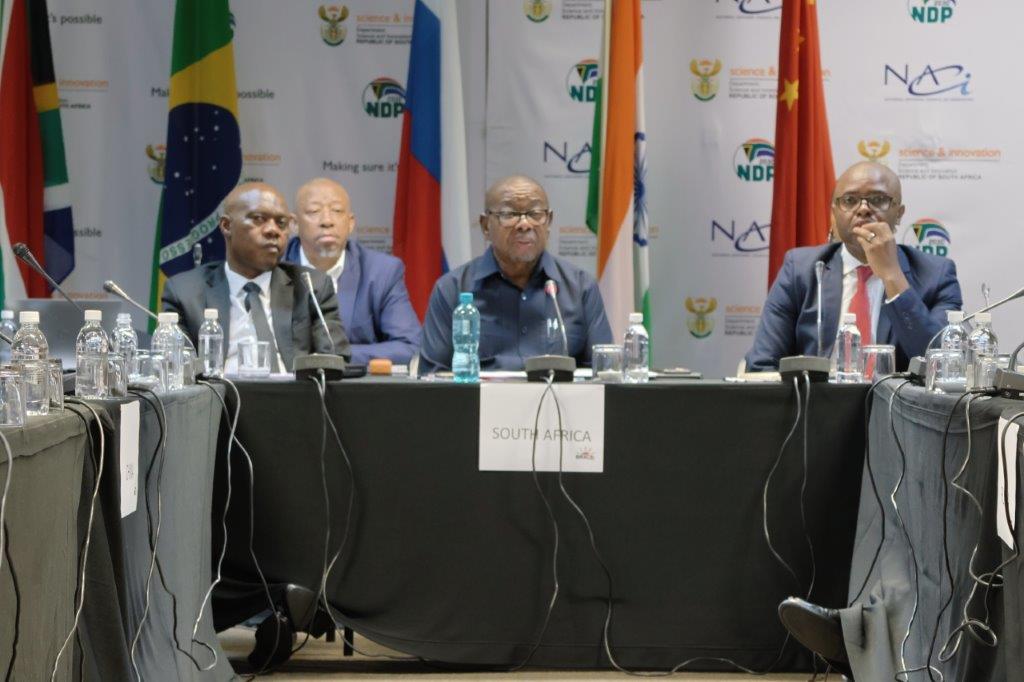 Minister of Higher Education, Science and Innovation Prof Blade Nzimande (Centre) flanked by NACI Chairperson, Mr Tilson Manyoni (Left) and NACI CEO, Dr Mlungisi Cele (Right) at the BRICS Science, Technology and Innovation Policy and Foresight Symposium held on the 4 - 5 December 2023 at the CSIR International Convention Centre, Pretoria, South Africa